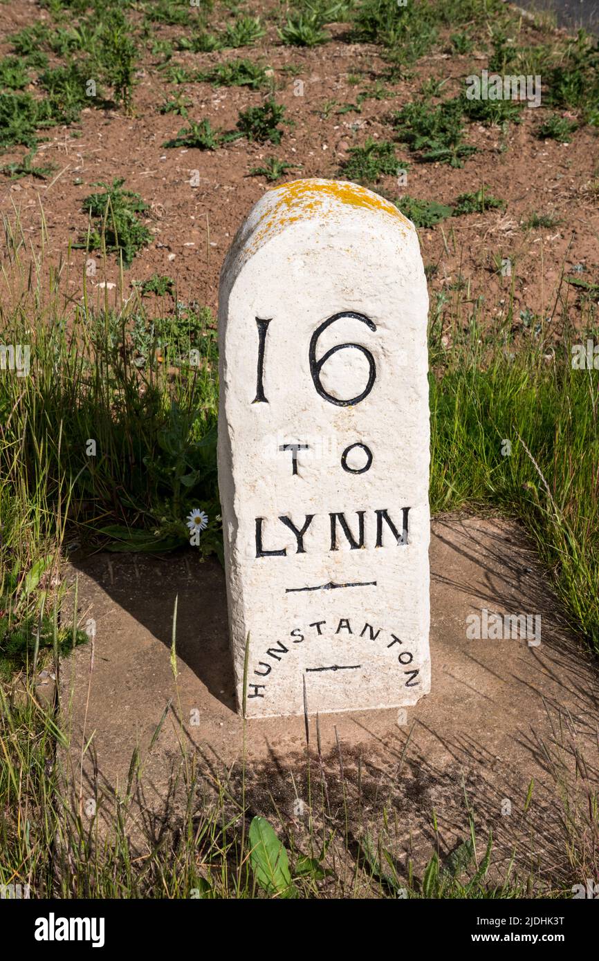 A stone milestone showing that it is 16 miles to King's Lynn from Hunstanton in Norfolk. Stock Photo