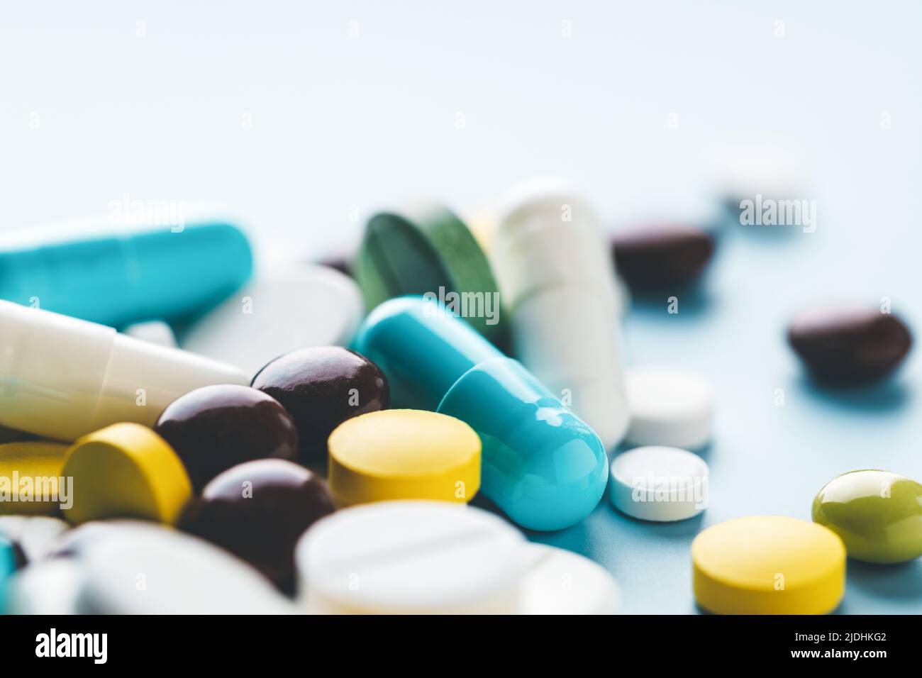 Various pills on blue background, angle view. Stock Photo