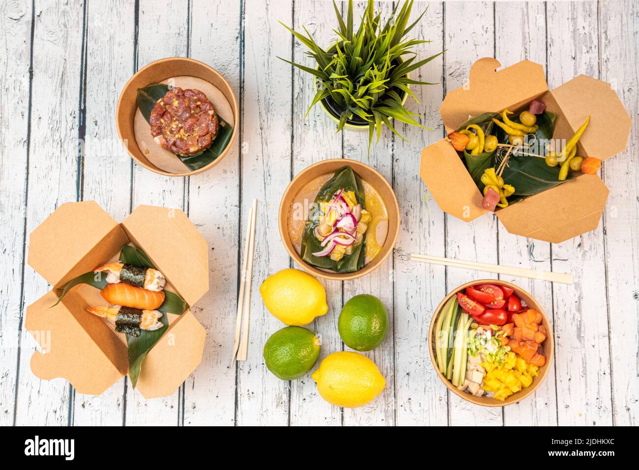 Set of asian healthy food dishes, with salmon poke bowl, nigiri, spicy banderillas, bluefin tuna tartare, ceviche with red onion, lemons and limes Stock Photo