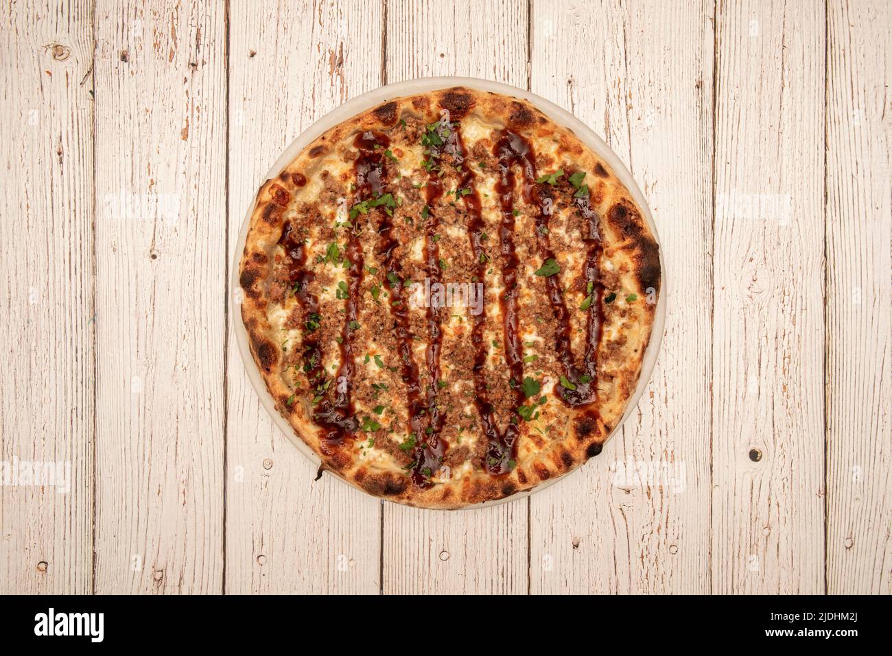 Top view image of bbq pizza, mozzarella cheese, sauce and parsley Stock Photo