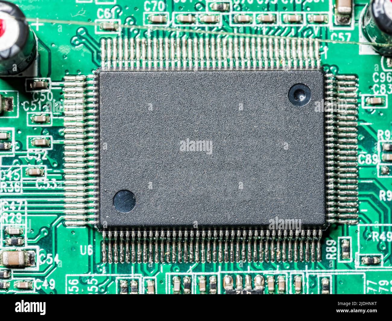 Closeup of microchip installed on PCB board shot from above Stock Photo