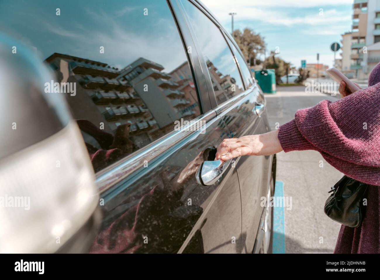 Woman touching the automotive exterior door handle Stock Photo