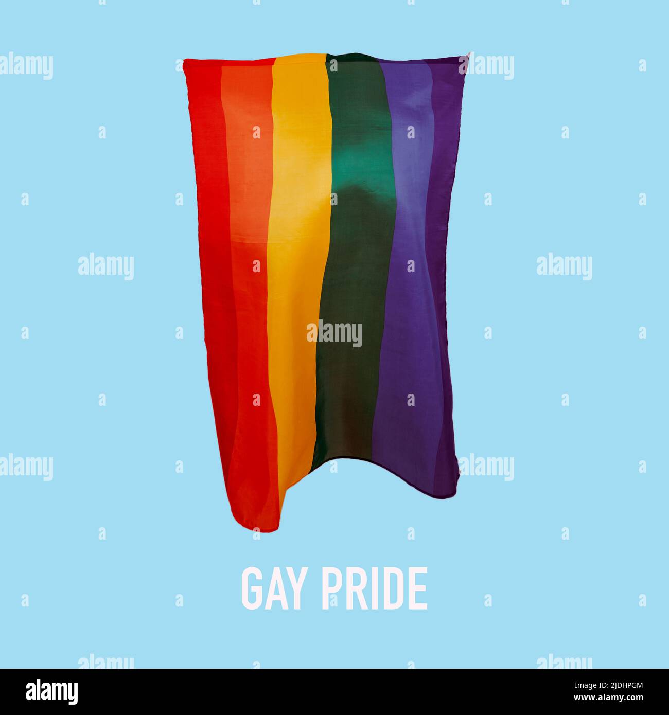 text gay pride and a rainbow pride flag waving in the air against a blue background Stock Photo