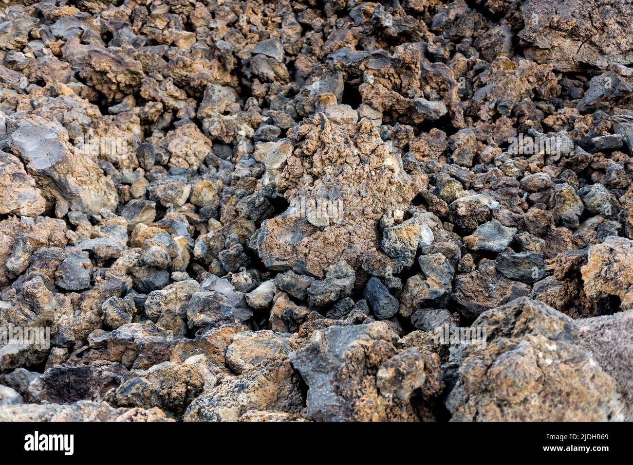 Rough, rugged solid lava rocks. Stock Photo