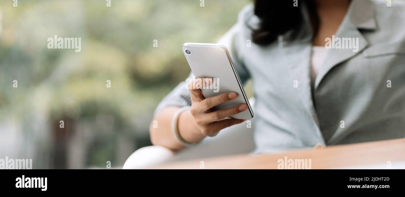 Close up business woman using smart phone, chatting social media.. Stock Photo