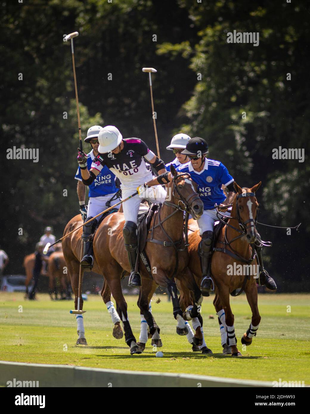Tomas Beresford of UAE blocks James Harper of King Power (in blue) at Cowdray Park Polo Club in Midhurst, West Sussex during the opening match of The Stock Photo