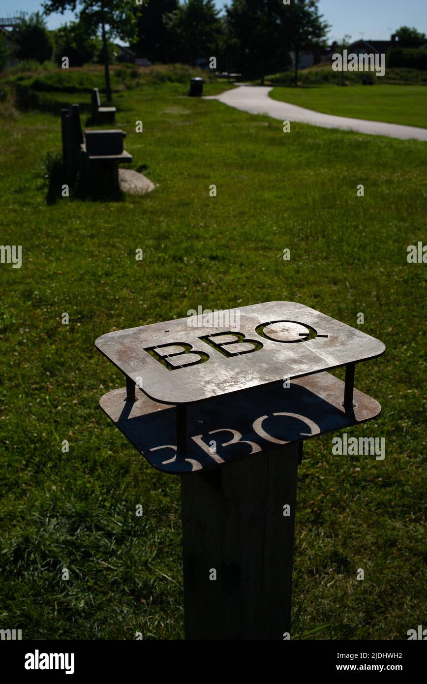 Metal barbecue safety stand for disposable barbecues in public park in