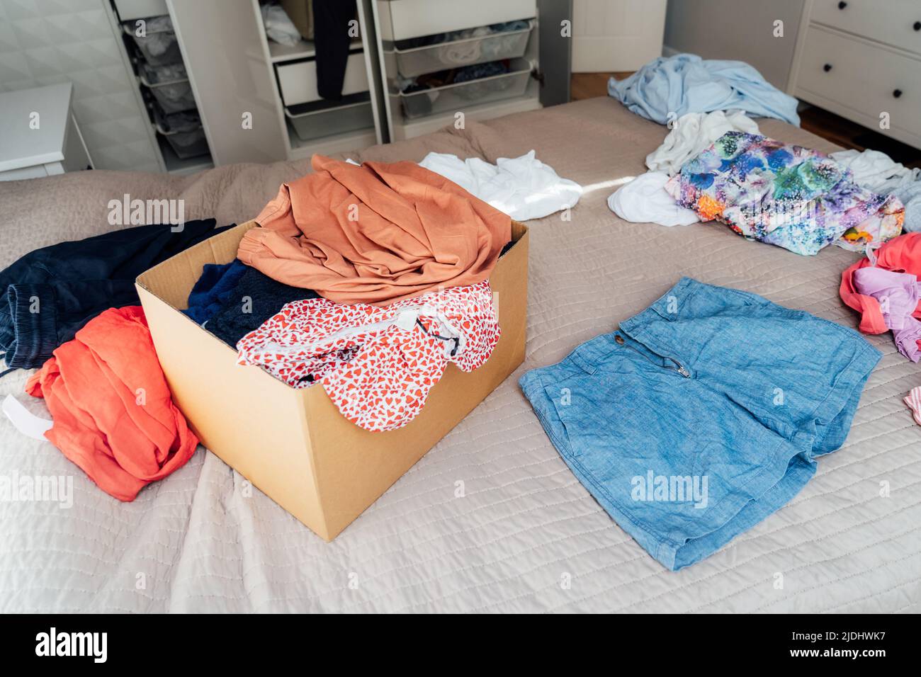 A cardboard box of selected clothes for donating to a Charity shop
