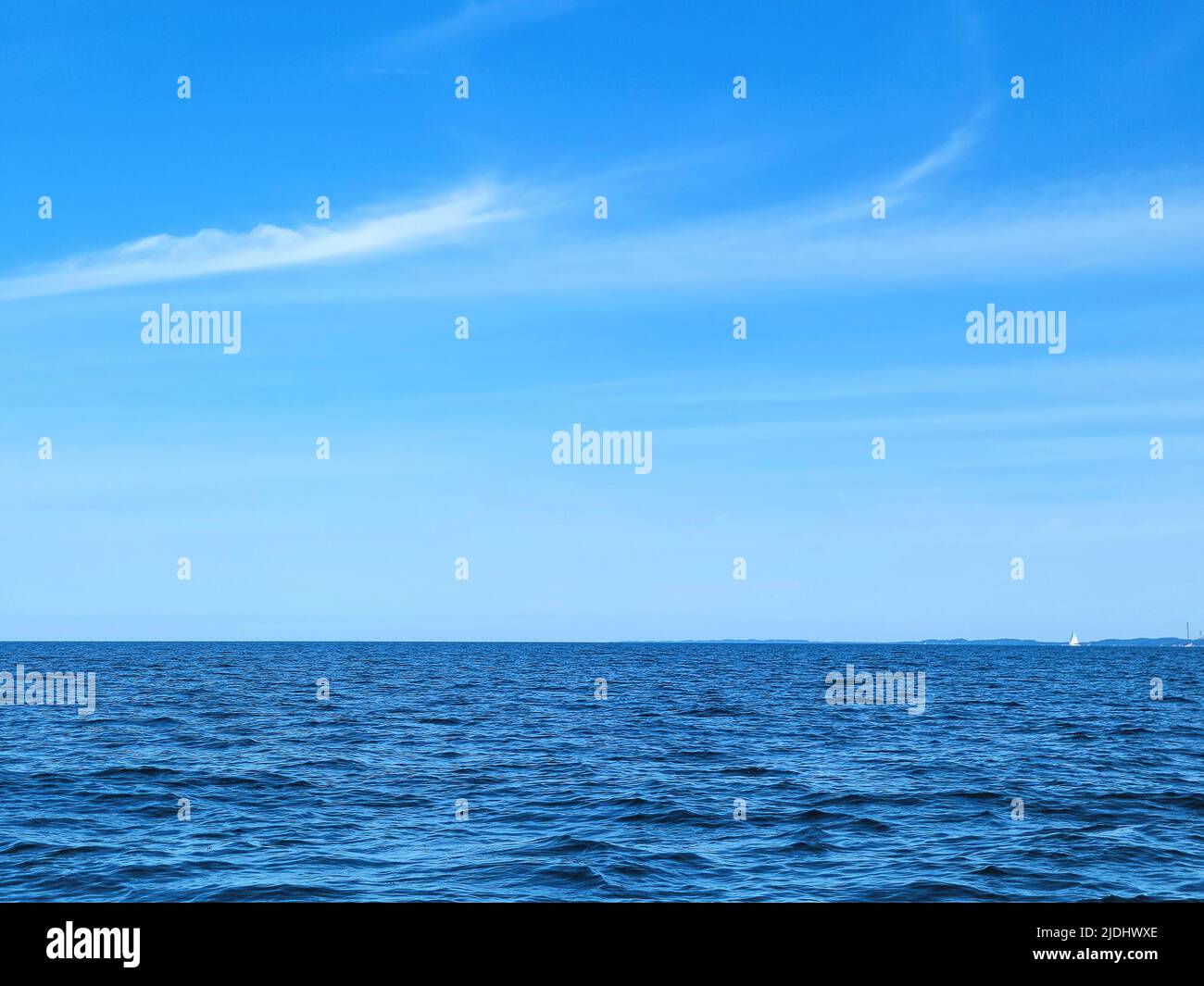 Blue Lake Michigan water with horizon and summer sky Stock Photo