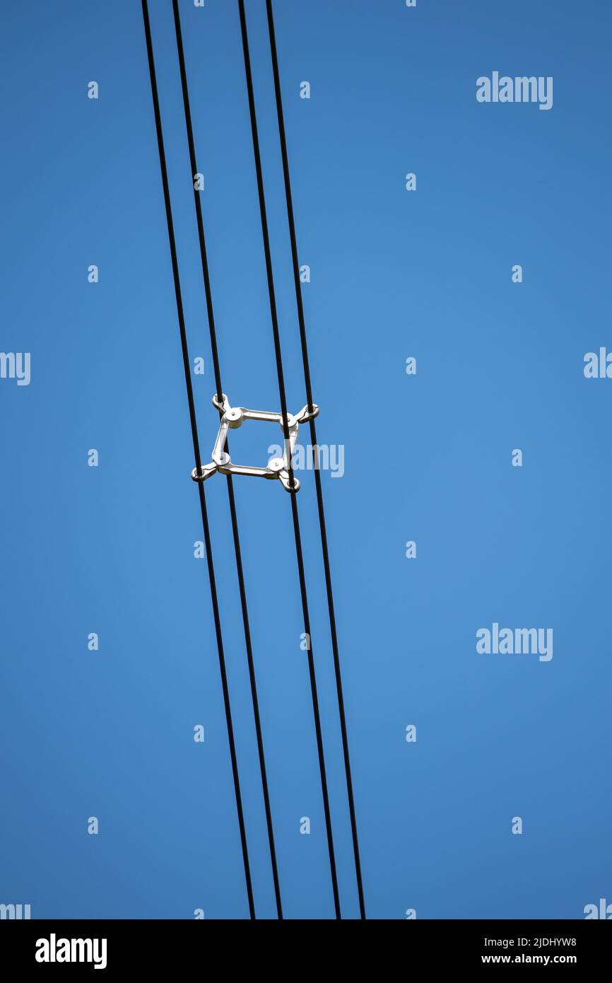 Close-up of the Spacers on a electricity lattice tower in the UK separating the high voltage cables. Stock Photo