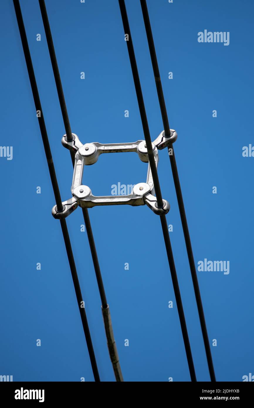 Close-up of the Spacers on a electricity lattice tower in the UK separating the high voltage cables. Stock Photo