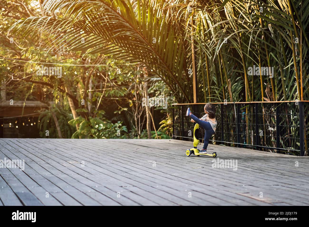 Asian kid enjoy playing and riding scooter without using any safety
