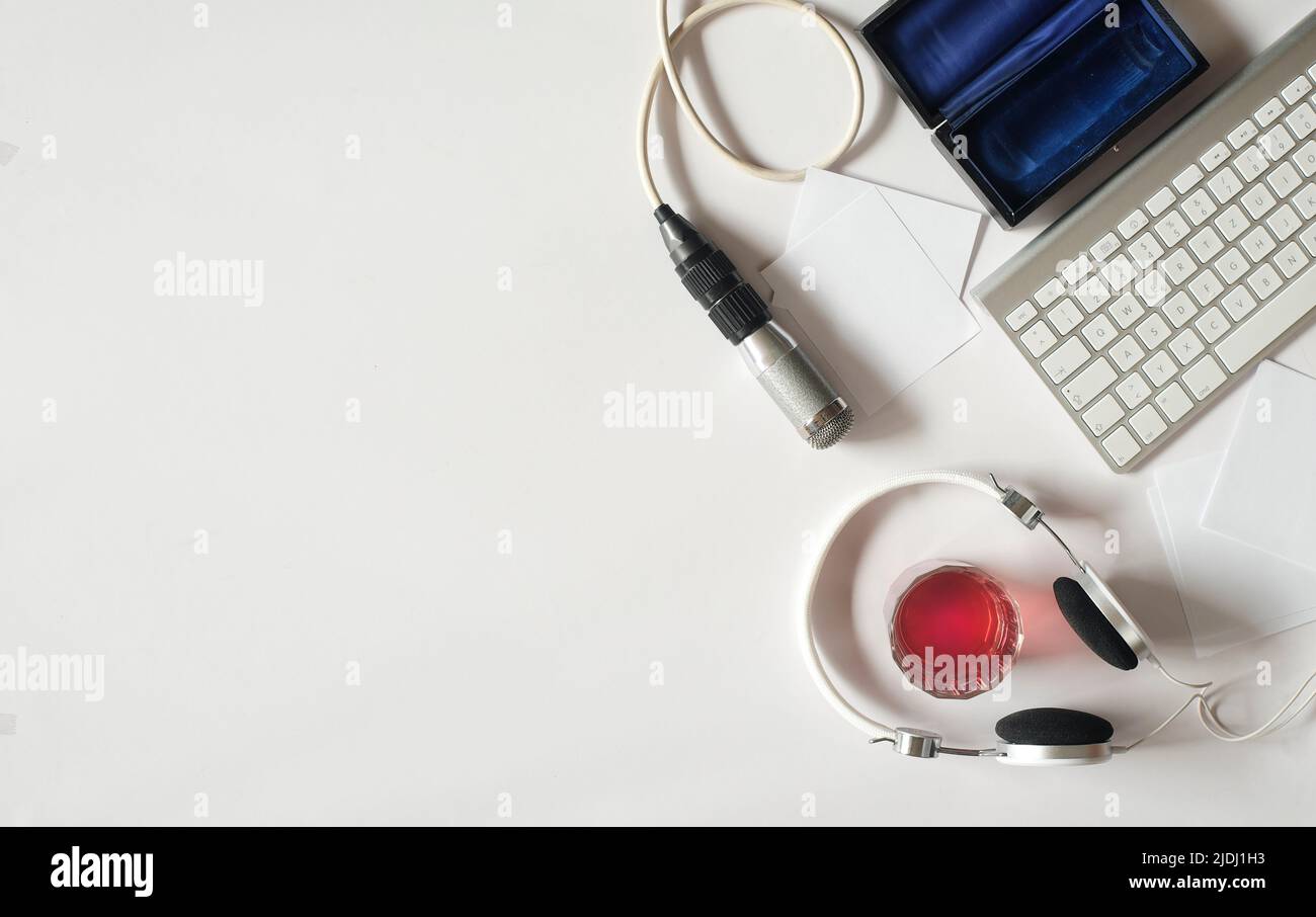 Podcasting concept, headphones, vintage microphone and computer keyboard on white background, free copy space Stock Photo