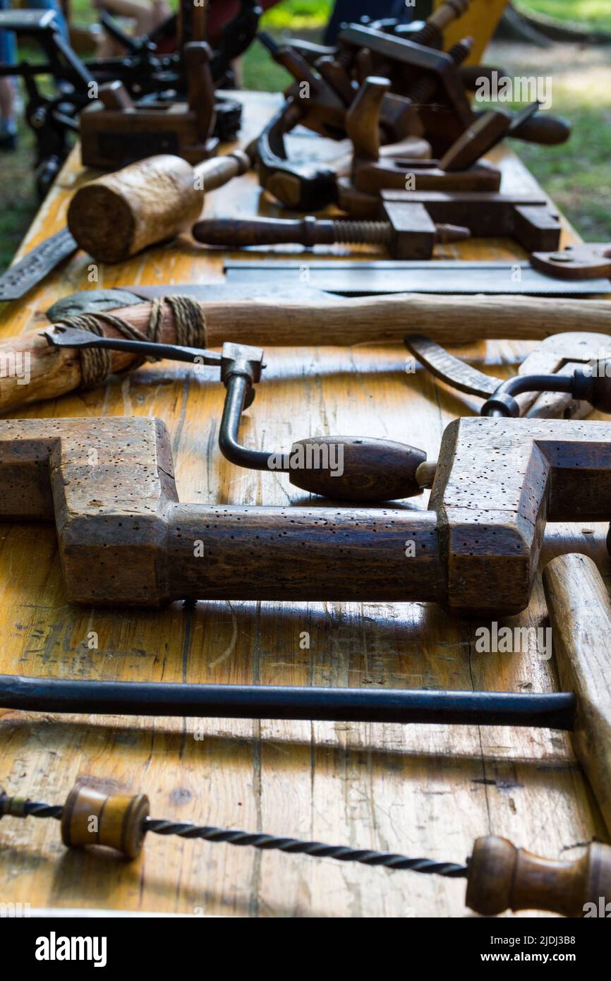 Traditional, vintage tools of woodcarver displayed on a festival Stock Photo