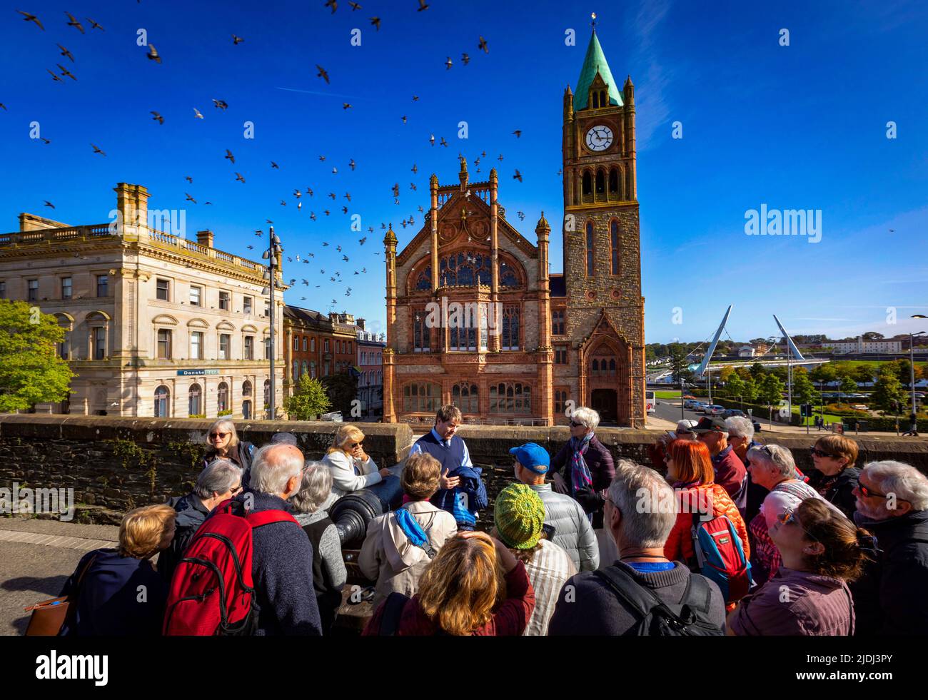 Tourists on Derry's City Walls in front of the Guildhall, Derry City, Northern Ireland Stock Photo