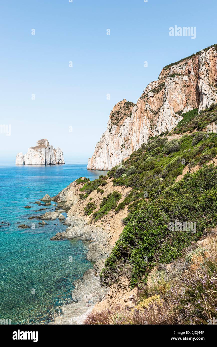 The rocky island of Pan di Zucchero rises out of the blue Mediterranean Sea off the cliff near Masua in the south-west of Sardinia Stock Photo