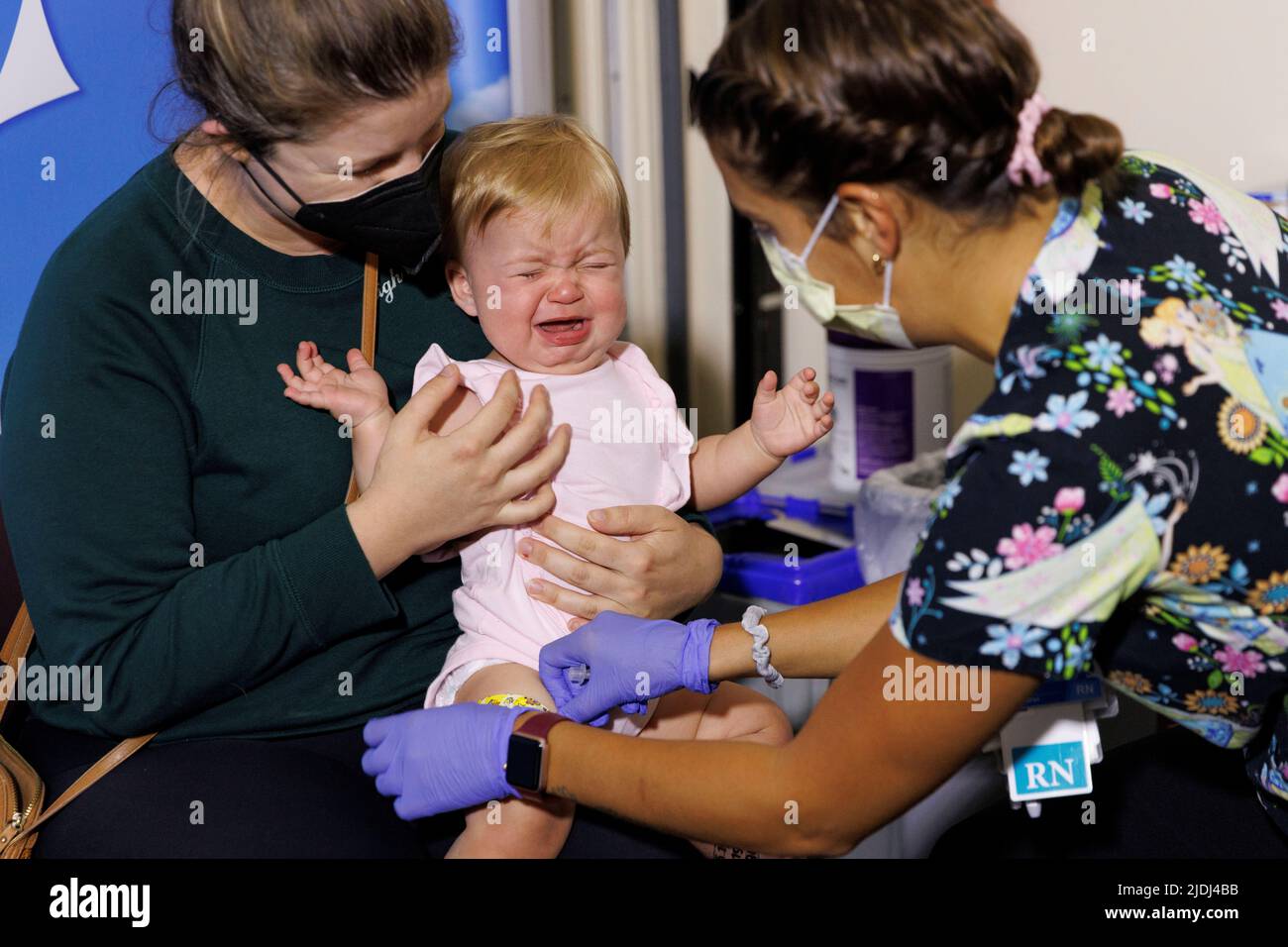 Following CDC approval for vaccination of children aged 6 months to 5 years, 10 month old Hazel Ribnik reacts, as nurse Jillian Mercer administers the Moderna vaccine for the coronavirus disease (COVID-19) at Rady Children’s Hospital in San Diego, California, U.S., June 21, 2022.  REUTERS/Mike Blake Stock Photo