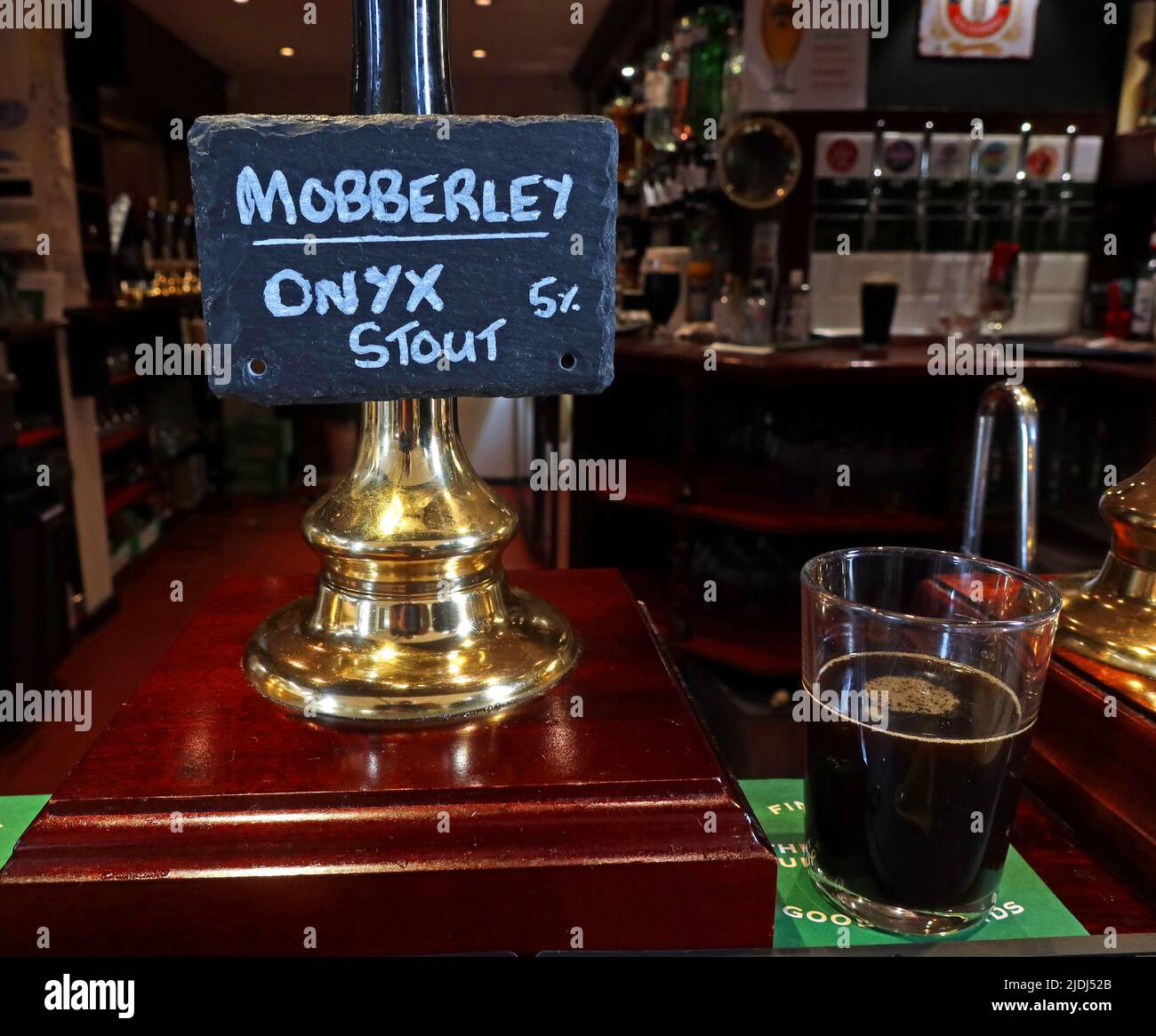 Traditional country brewery real ale, handpump with Mobberley Brewery, Onyx Stout 5%, dark porter style brew, at Appleton Thorn village hall,Cheshire Stock Photo