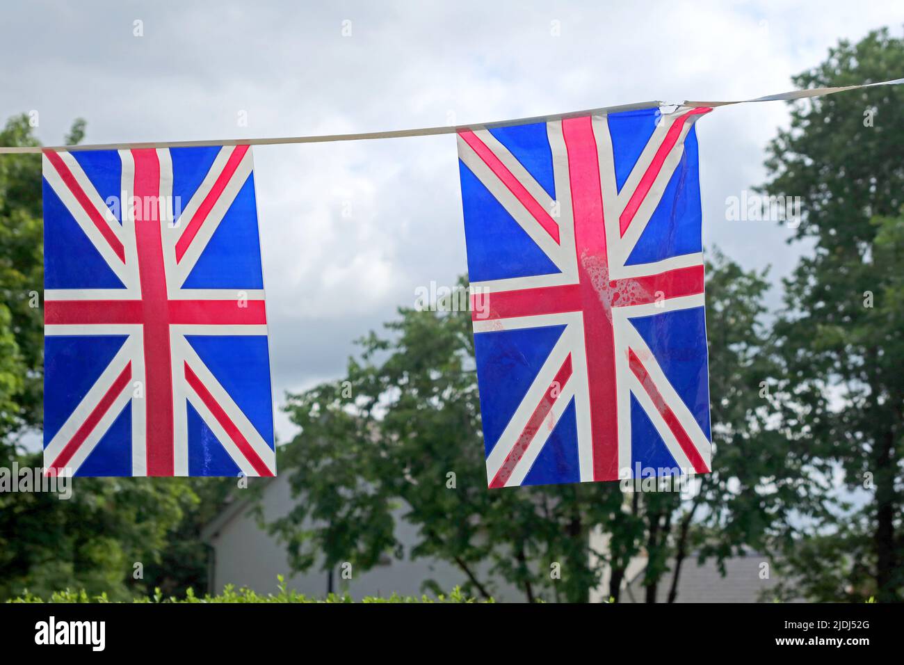 Two union jack flags - royal events, Jubllee, death of Queen Elizabeth, coronation of King Charles III Stock Photo