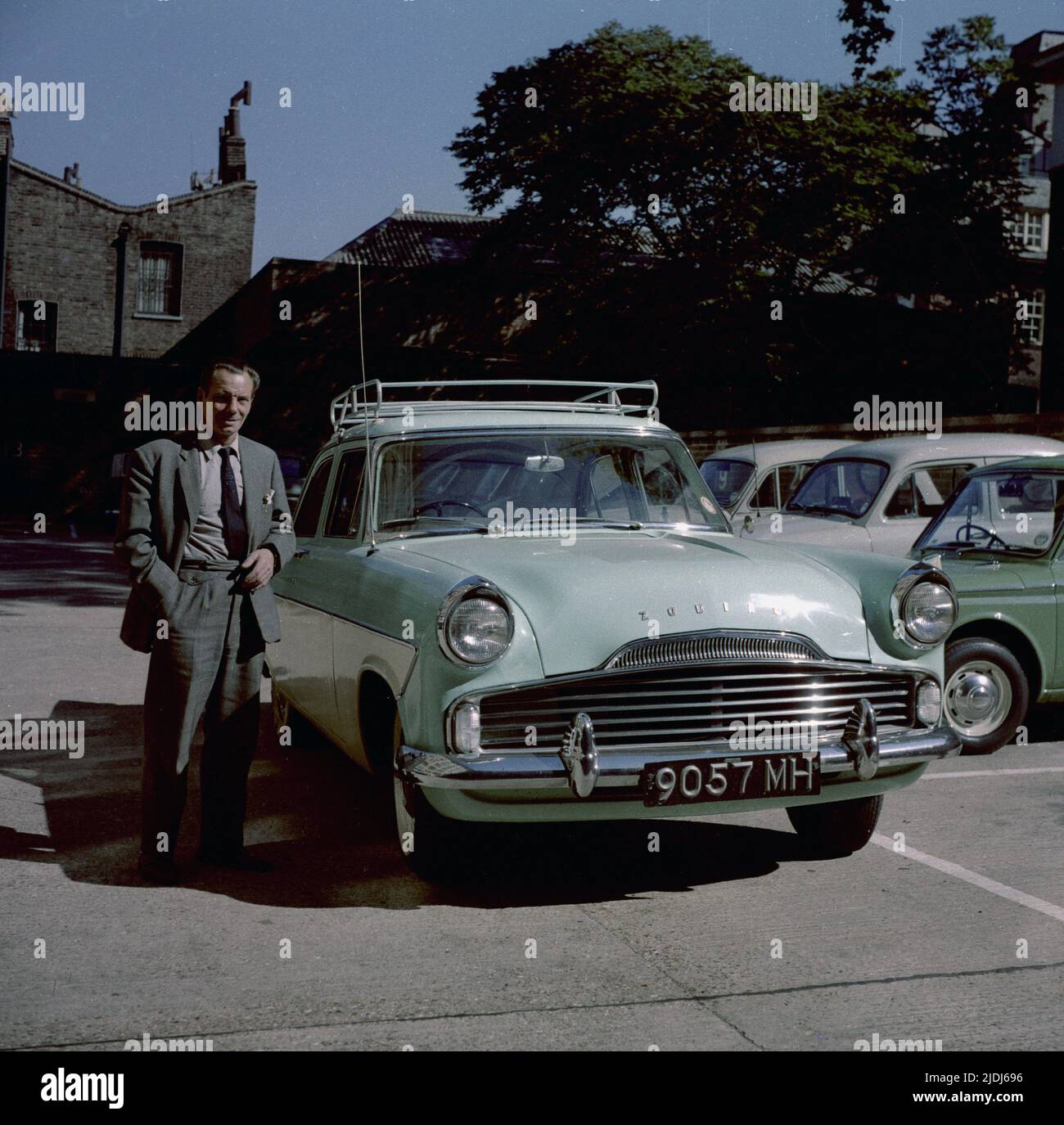 1964, historical, a gentleman in a suit & tie, standing in a car park by his motorcar of the era, a tone-tone, British Ford Zodiac, England, UK. Stock Photo