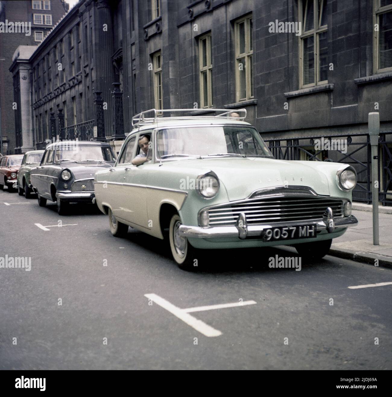 1964, historical, a man sitting in his car of the era, a tone-tone, British Ford Zodiac, parked in a street, England, UK. Stock Photo