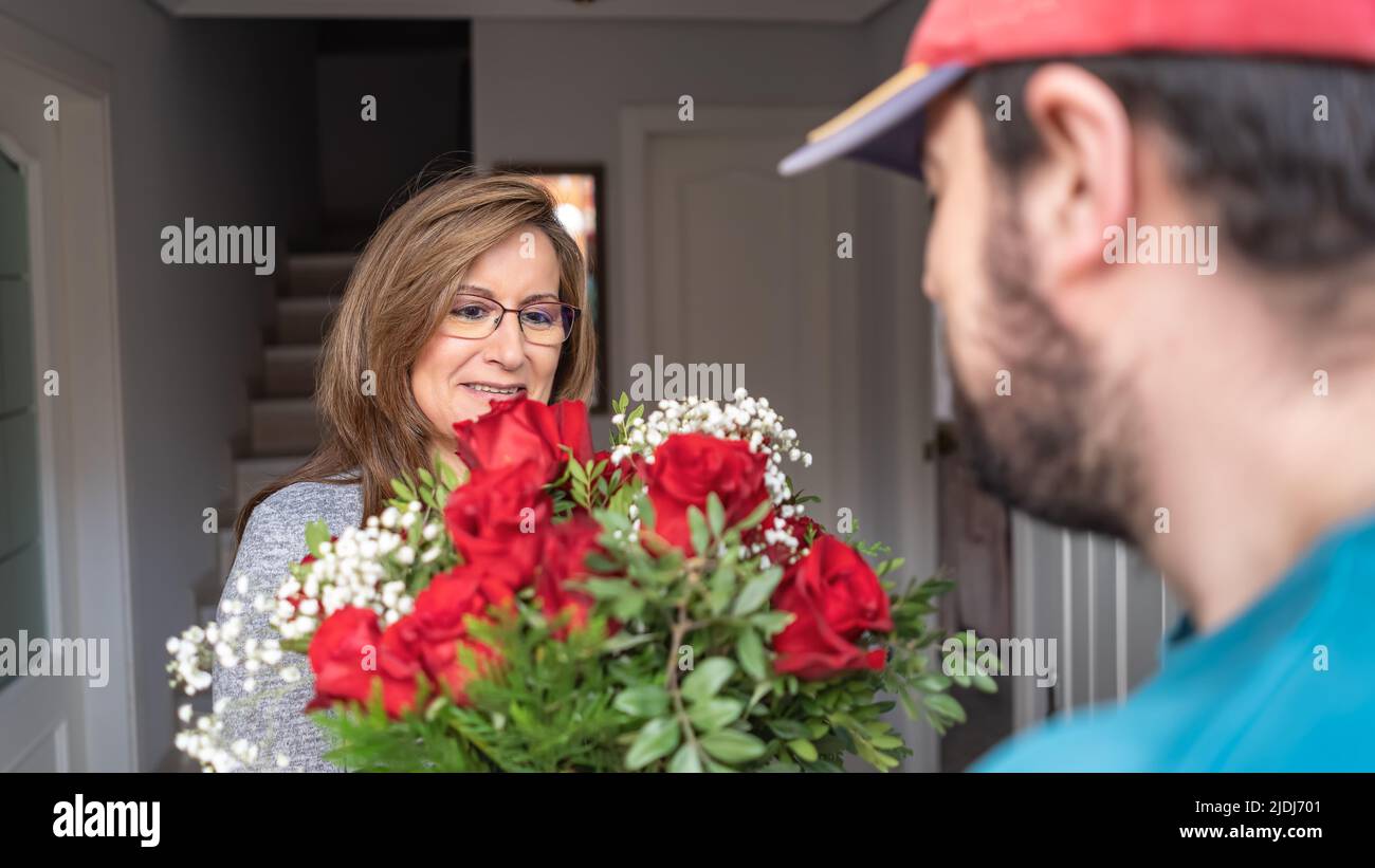 Man Getting Roses Man at door with roses hi-res stock photography and images - Alamy