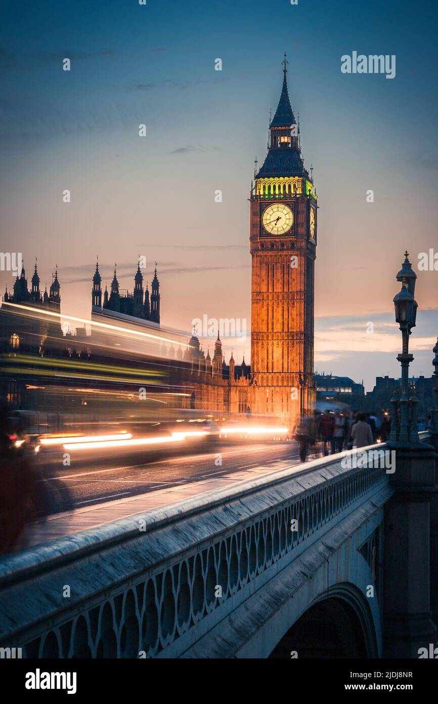 Big Ben at Dusk, London. An early evening view over Westminster Bridge and Big Ben. Long exposure with intentional motion blur of passing traffic. Stock Photo