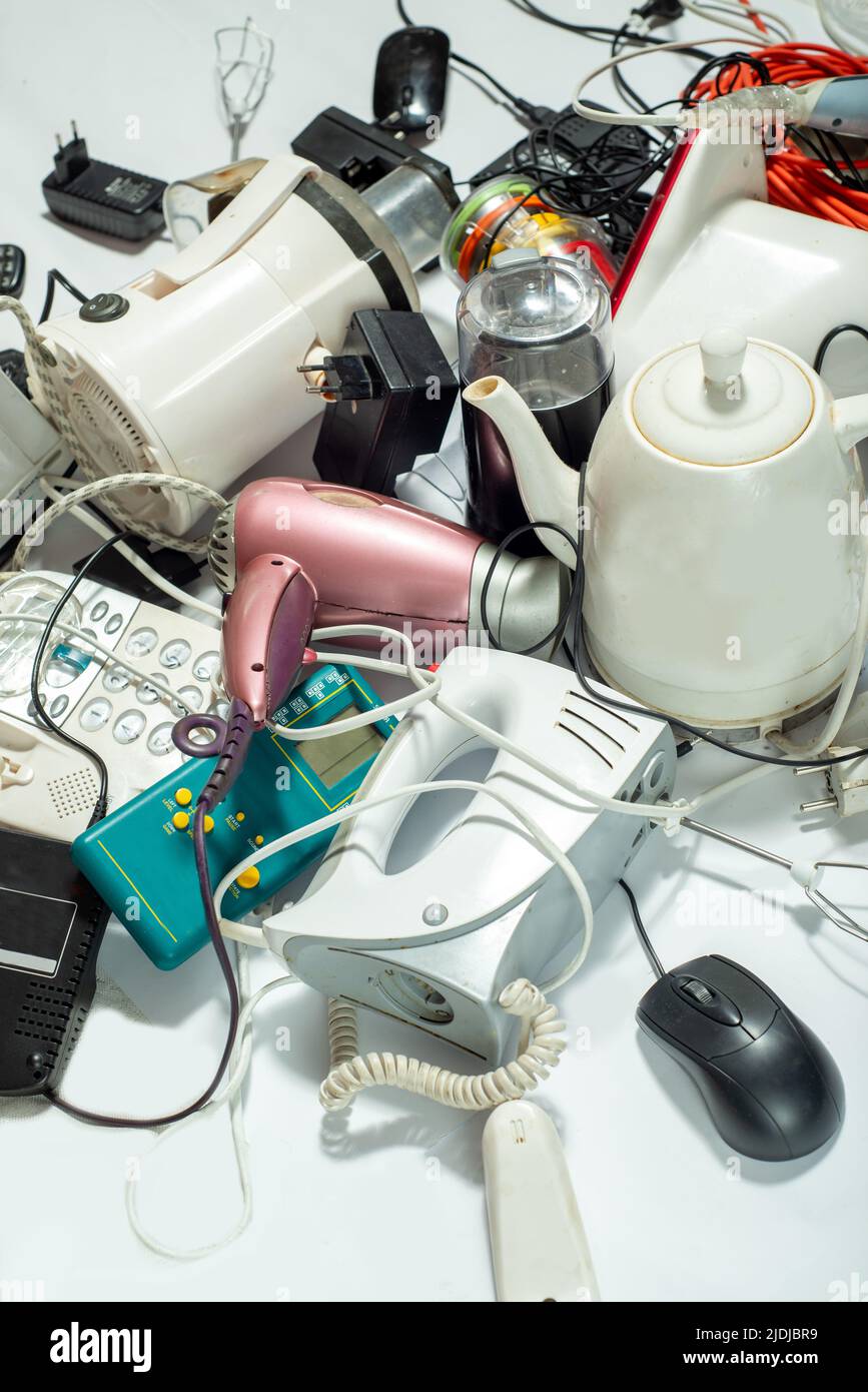 Lots of old electrical appliances for recycling e-waste. Sustainable living concept. Stock Photo