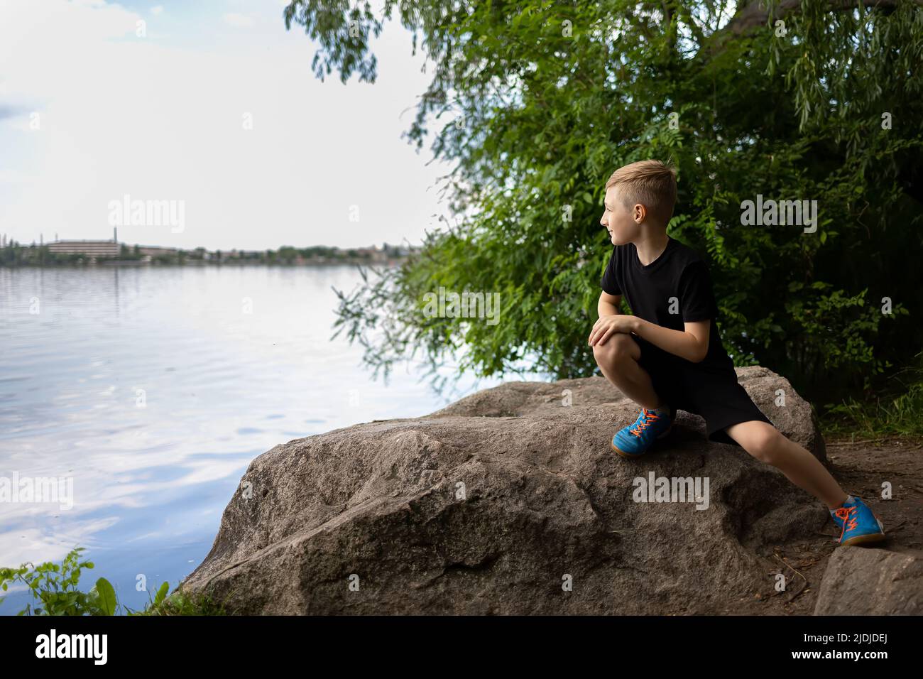 Child Move To The Edge Of The Stone To Look At The River Stock Photo child-move-to-the-edge-of-the-stone-to-look-at-the-river-stock-photo