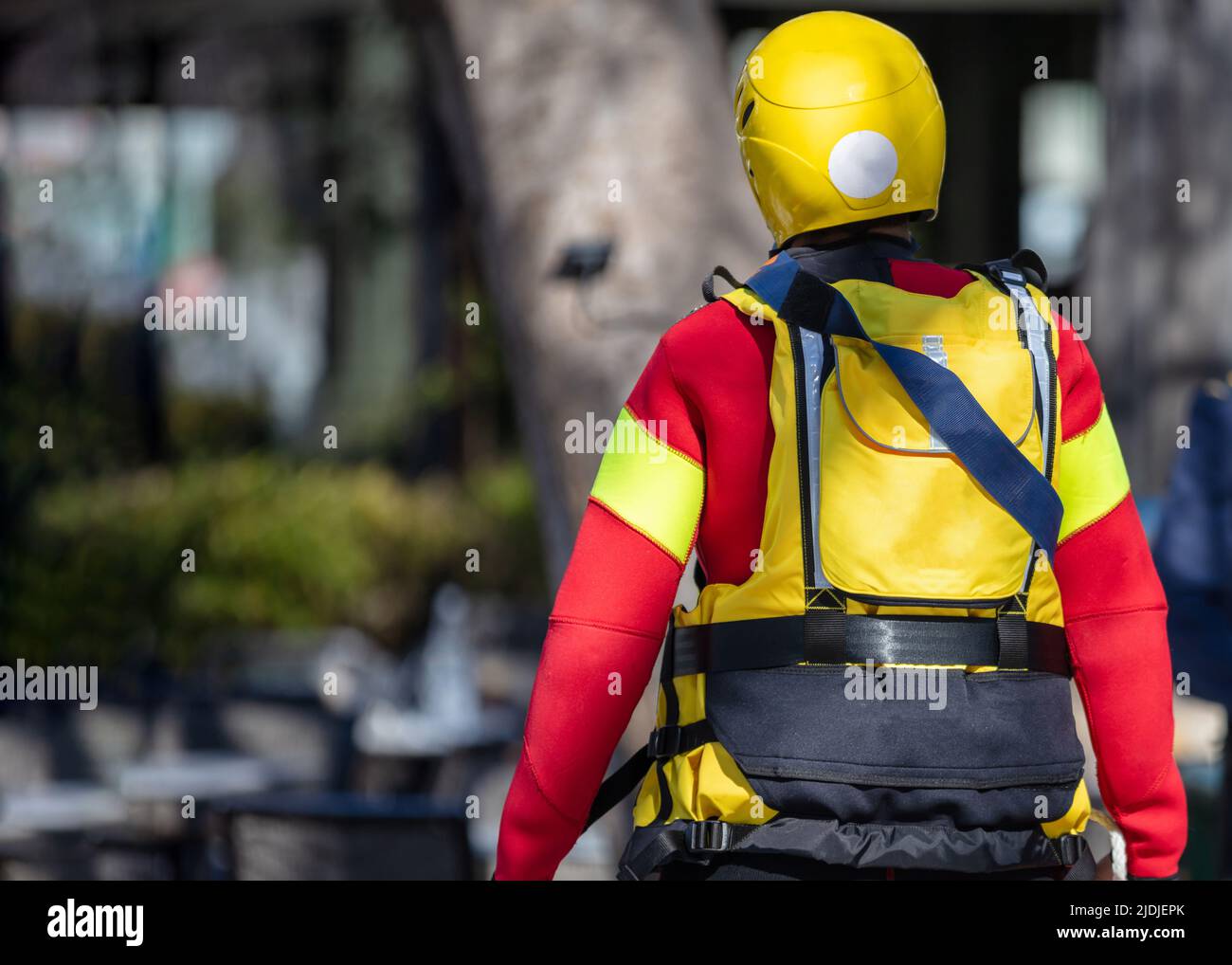 Volunteer of Nonprofit Organization with full equipment, rear view. First Aid, Emergency Medic Assistance. Stock Photo