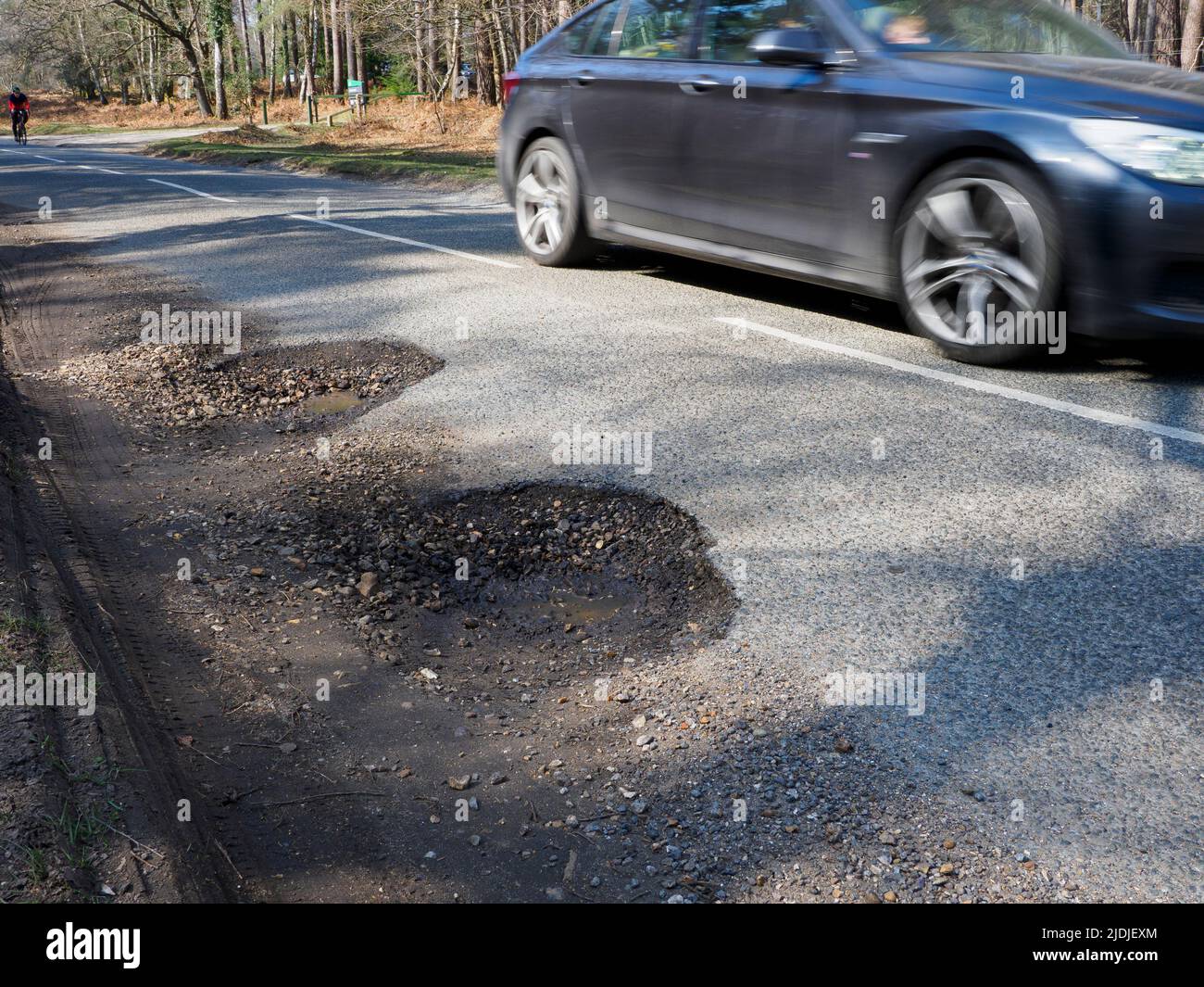 Potholes on a road in The New Forest, Hampshire, UK Stock Photo