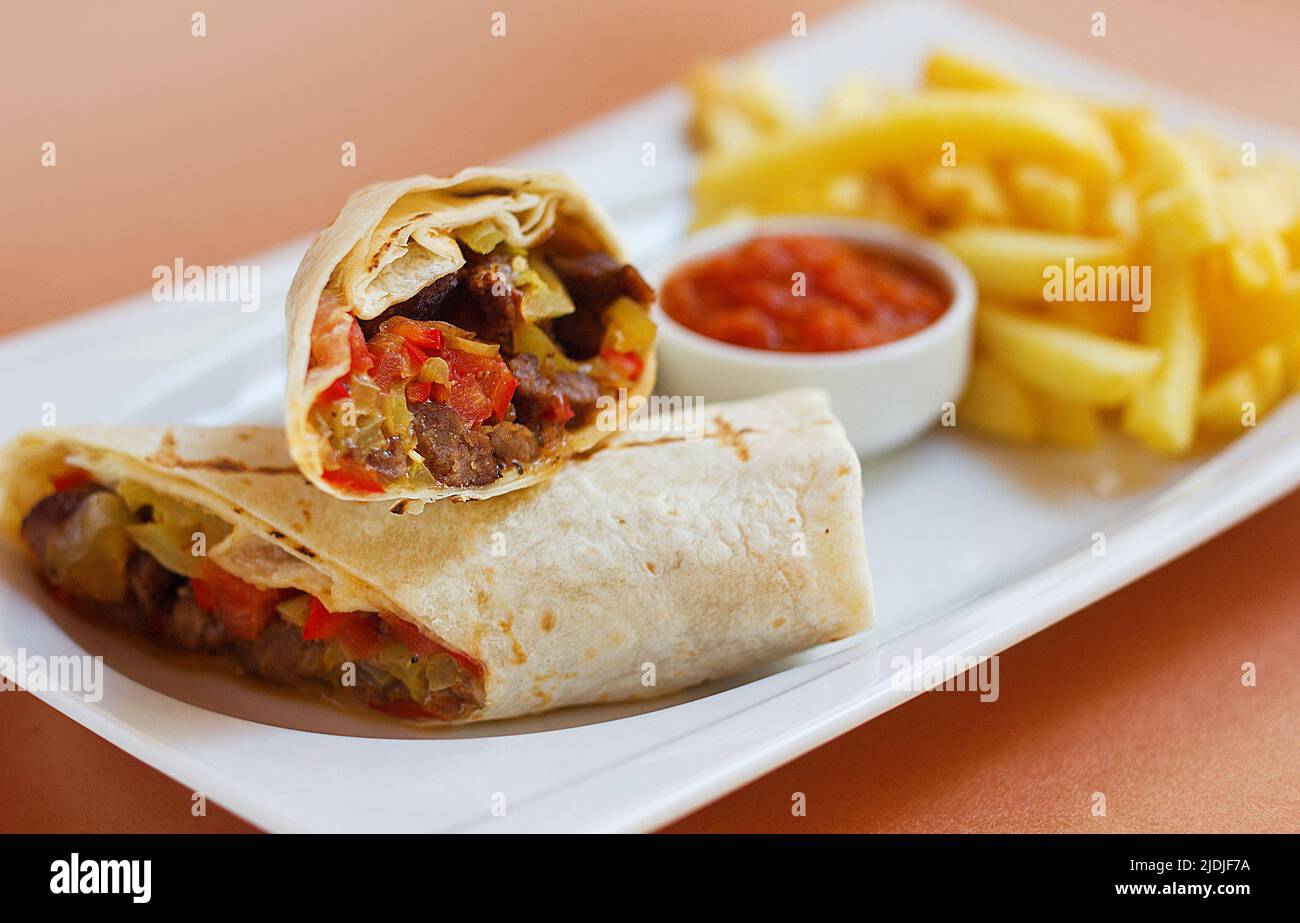 Meat Wrap with sause and fried potatoes Stock Photo