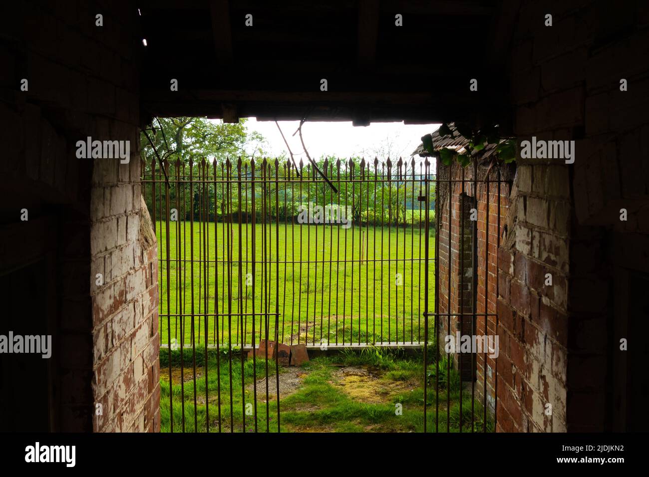 the inside of an old brick built Victorian dog kennels with iron