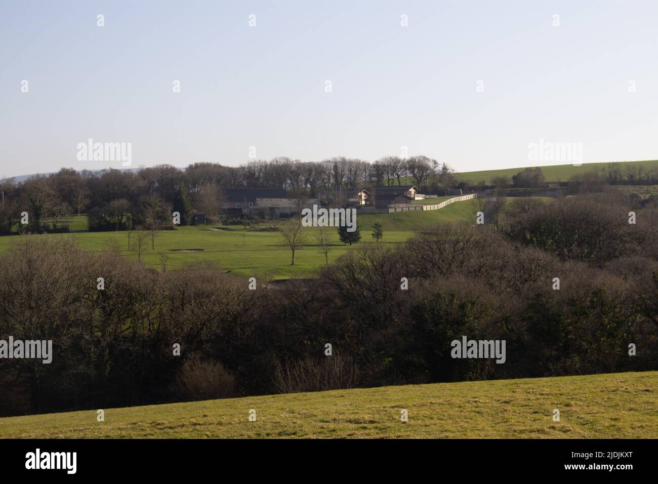 typical North Devon farm land with fields, hedges and a golf course in