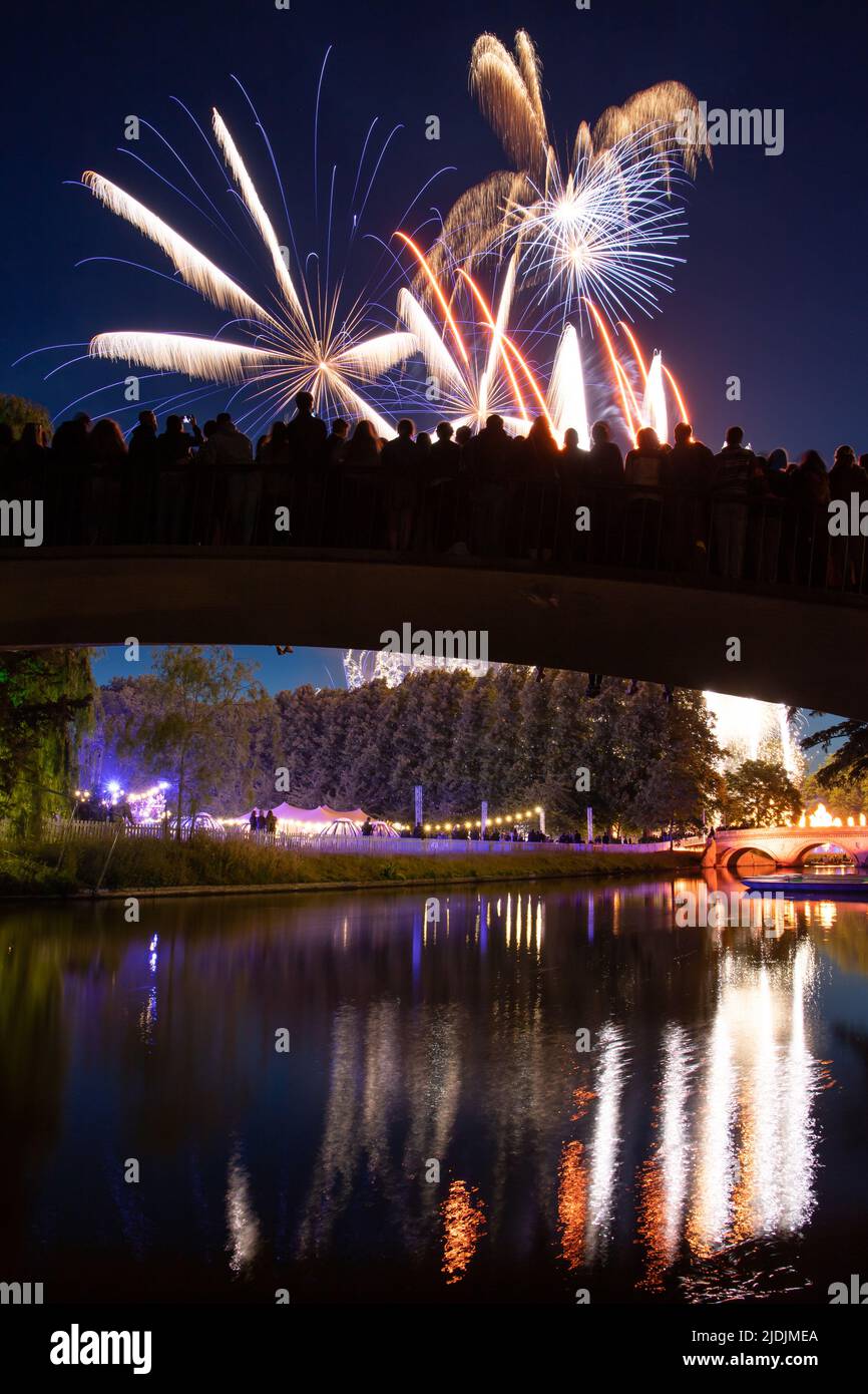 A crowd watches the Trinity May Ball fireworks from Garret Hostel Bridge, at the University of Cambridge, June 2022. Stock Photo