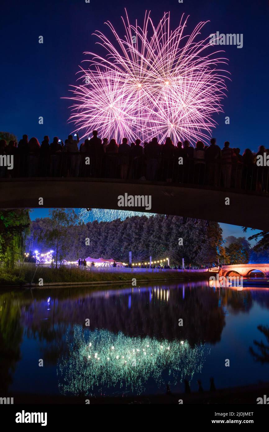 A crowd watches the Trinity May Ball fireworks from Garret Hostel Bridge, at the University of Cambridge, June 2022. Stock Photo