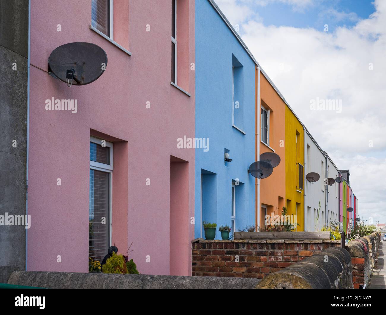 A terrace of houses in Cambois, Northumberland, UK painted in various colours Stock Photo