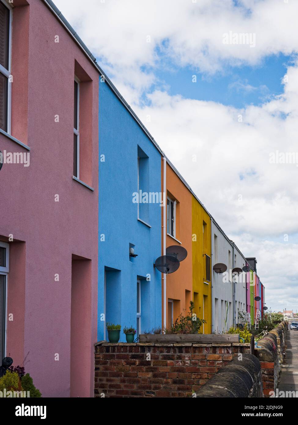 A terrace of houses in Cambois, Northumberland, UK painted in various colours Stock Photo
