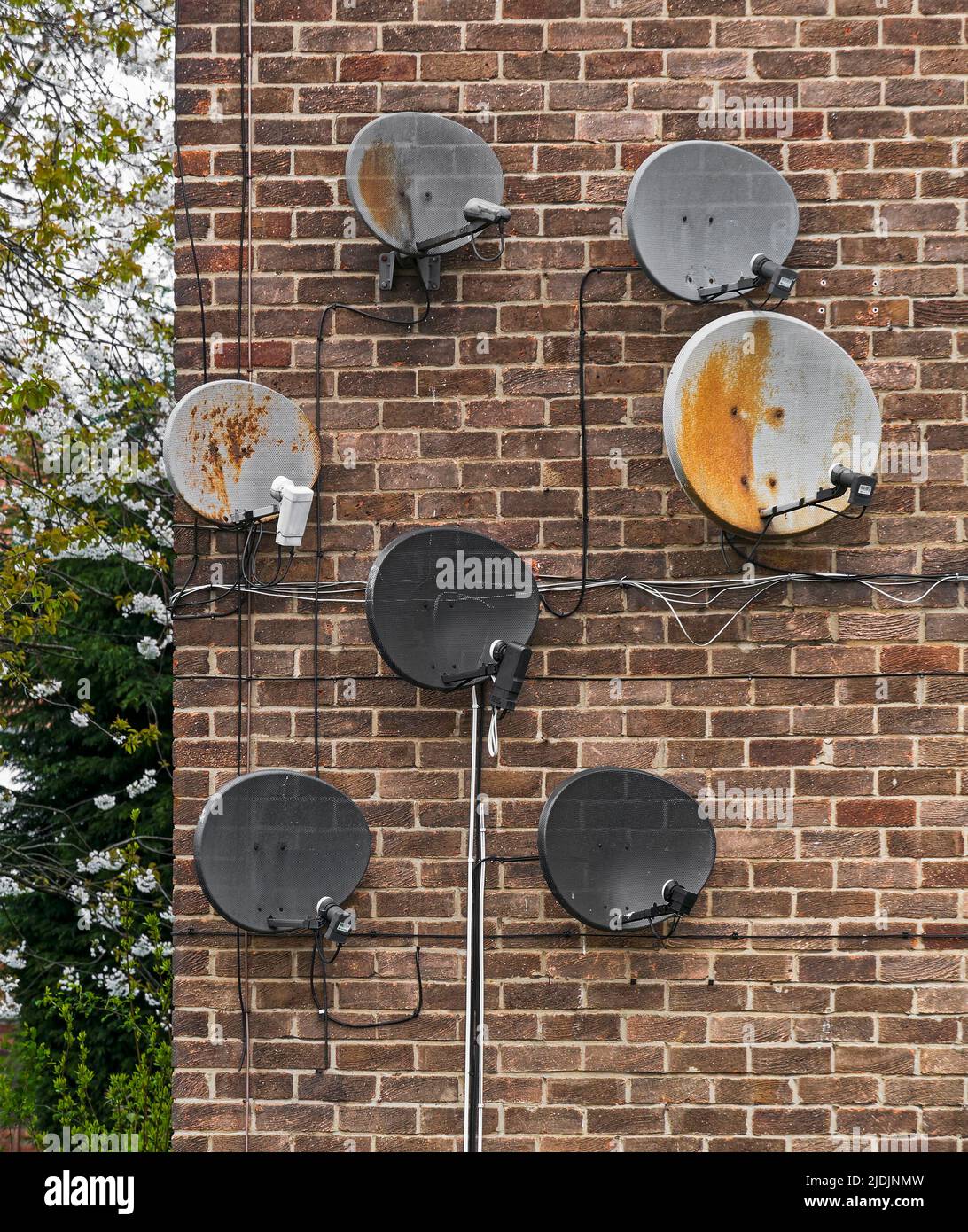 Satellite dishes on a building wall at Gosforth, Newcastle upon Tyne, UK Stock Photo