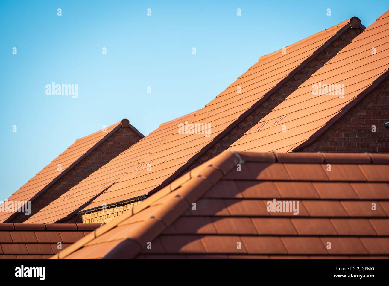 new built houses over clear blue sky in england uk Stock Photo - Alamy