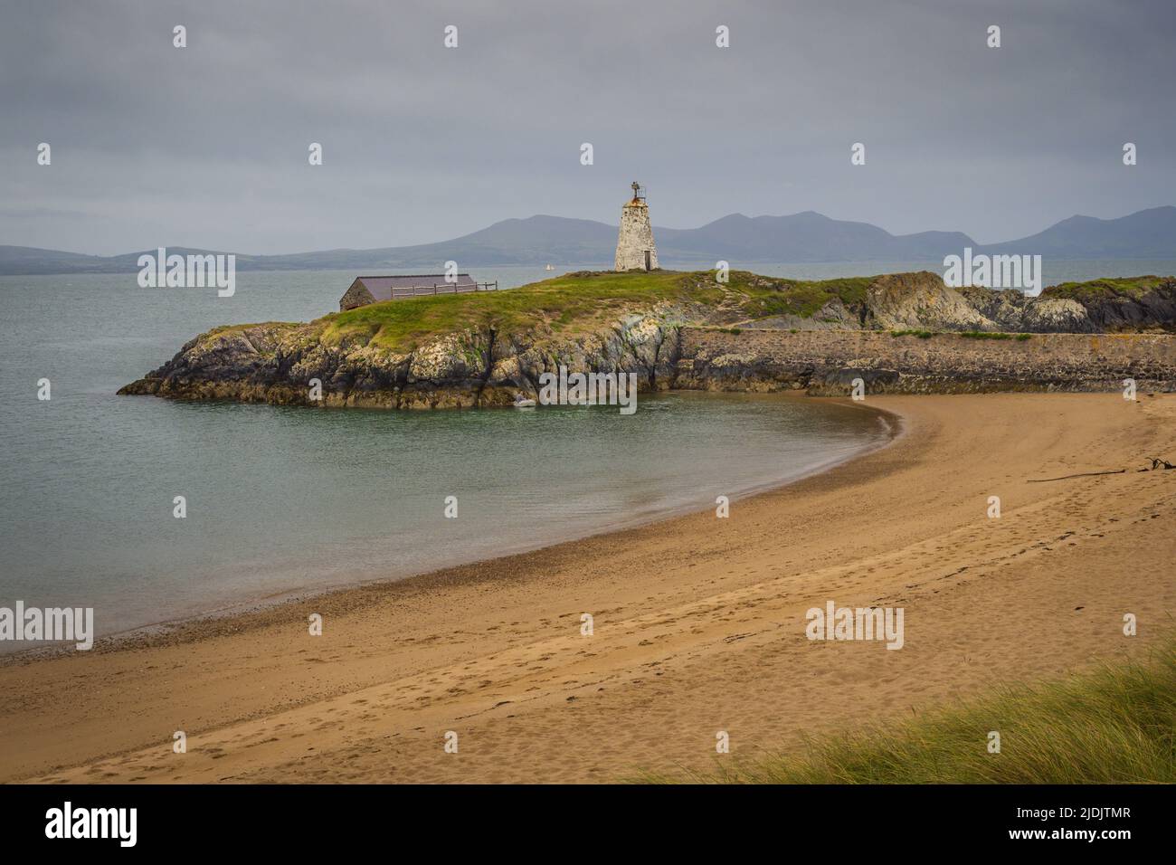 Newborough Warren and Ynys Llanddwyn was declared the first coastal National Nature Reserve in Wales in 1955. The Corsican pine trees that make up New Stock Photo