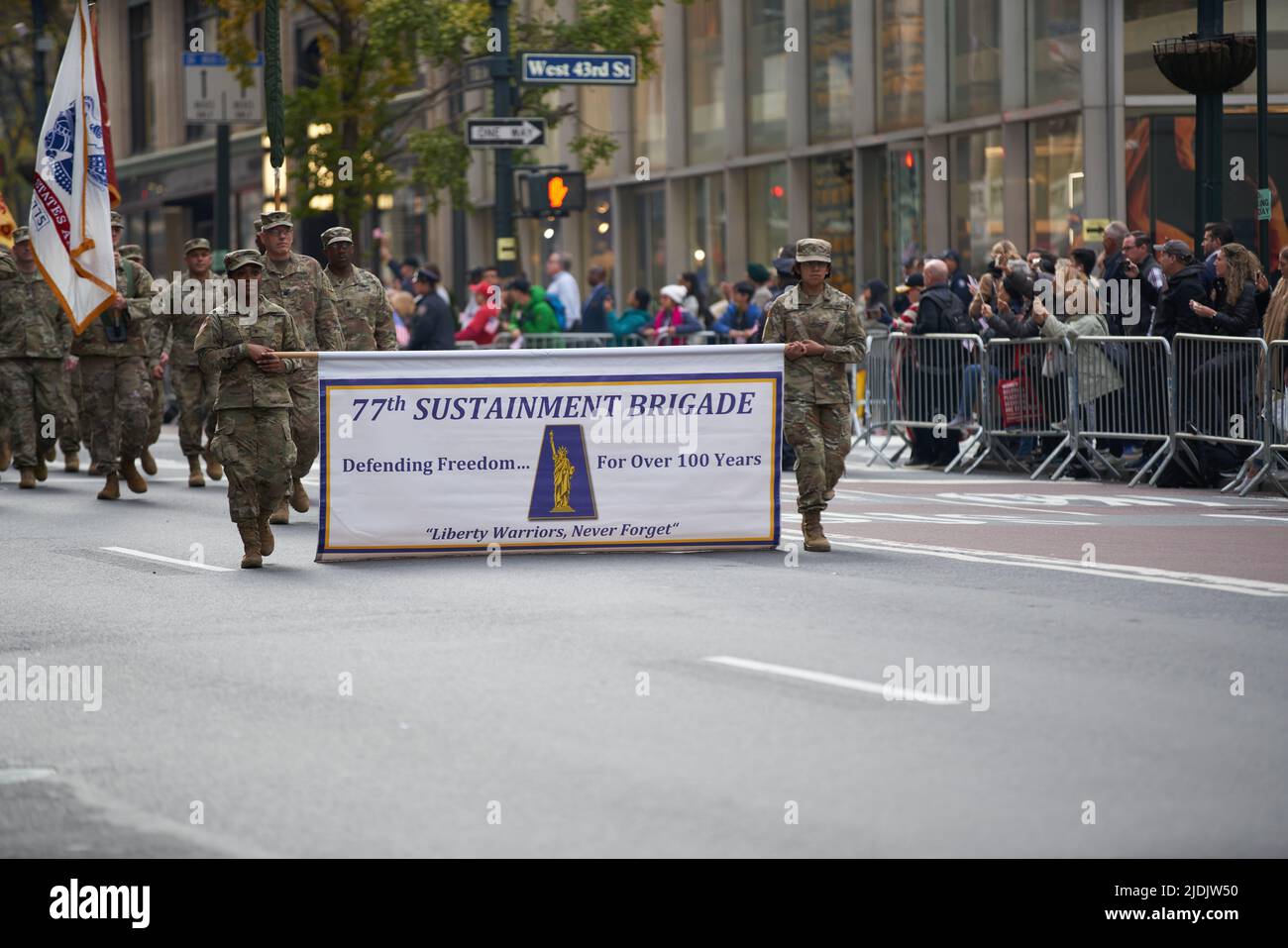 Manhattan, New York,USA - November 11. 2019: 77th Sustainment Brigade Banner. Soldiers marching on Fifth Avenue in NYC. US Military Infantry Stock Photo