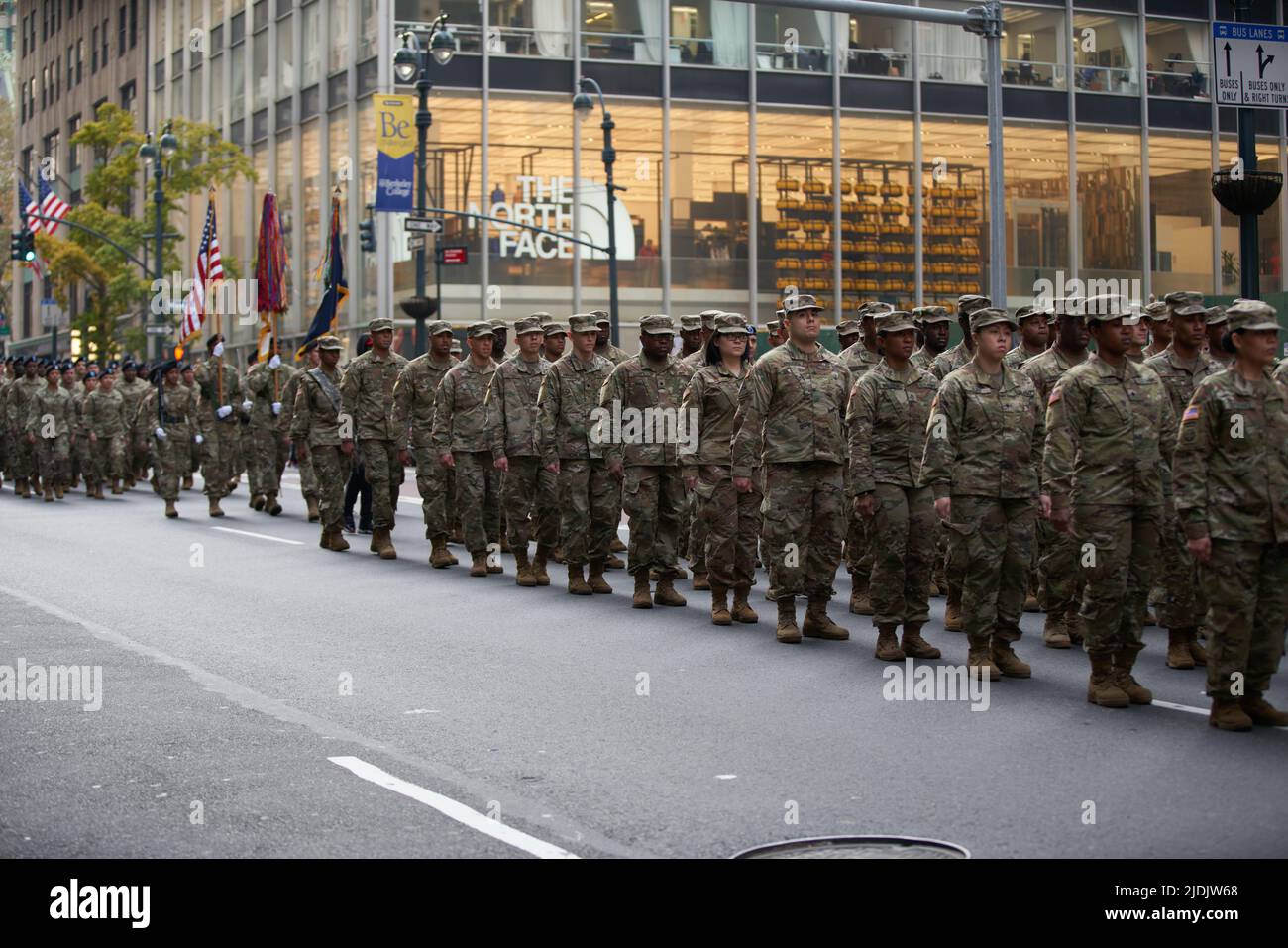 Manhattan, New York,USA - November 11. 2019: 77th U.S. Army Soldiers marching on Fifth Avenue in NYC. US Military Infantry holding flags and waring ca Stock Photo