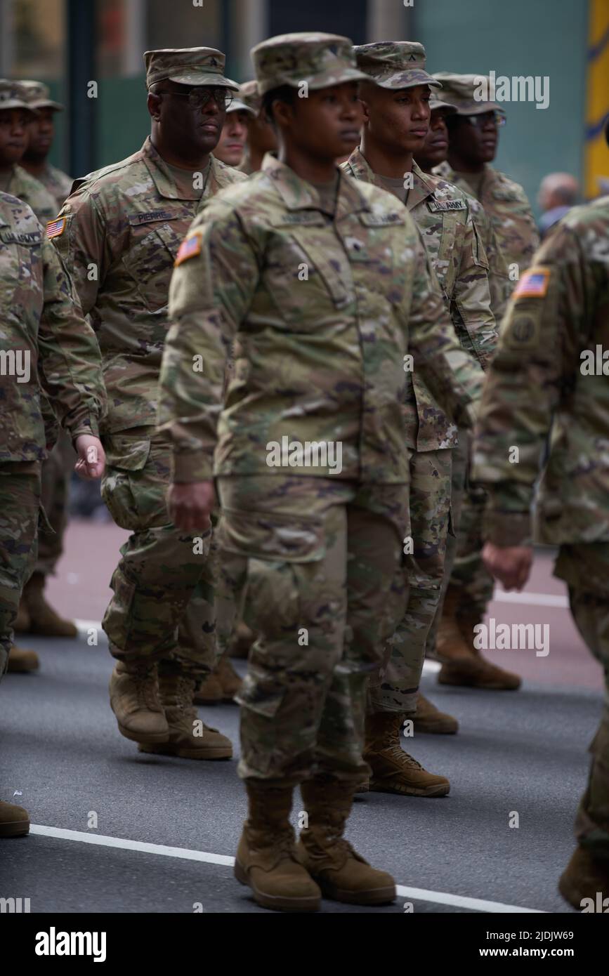 Manhattan, New York,USA - November 11. 2019: 77th U.S. Army Soldiers marching on Fifth Avenue in NYC. US Military Infantry waring camouflage uniforms. Stock Photo