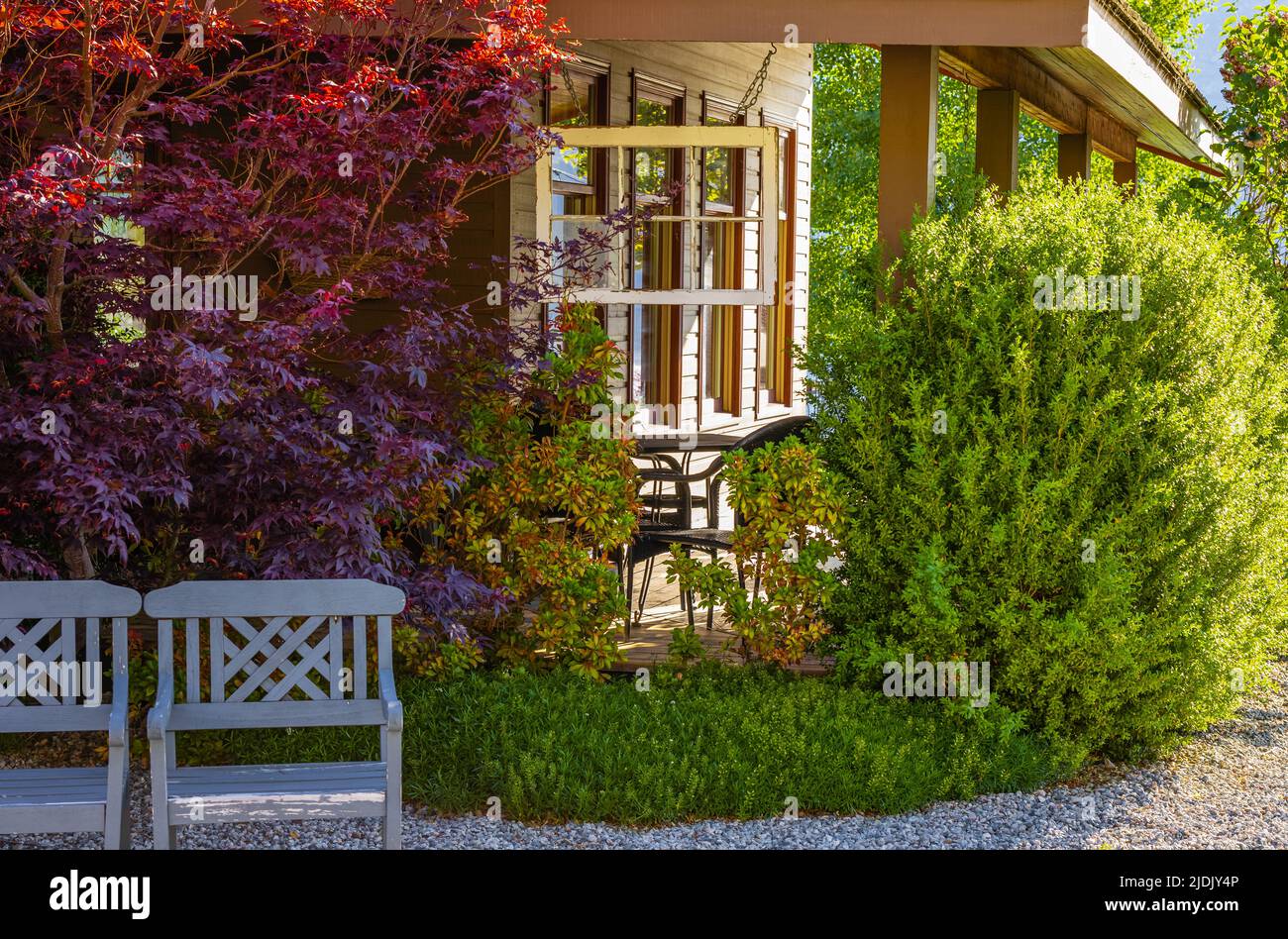 Family house patio and green lawn of the front yard in suburban area of