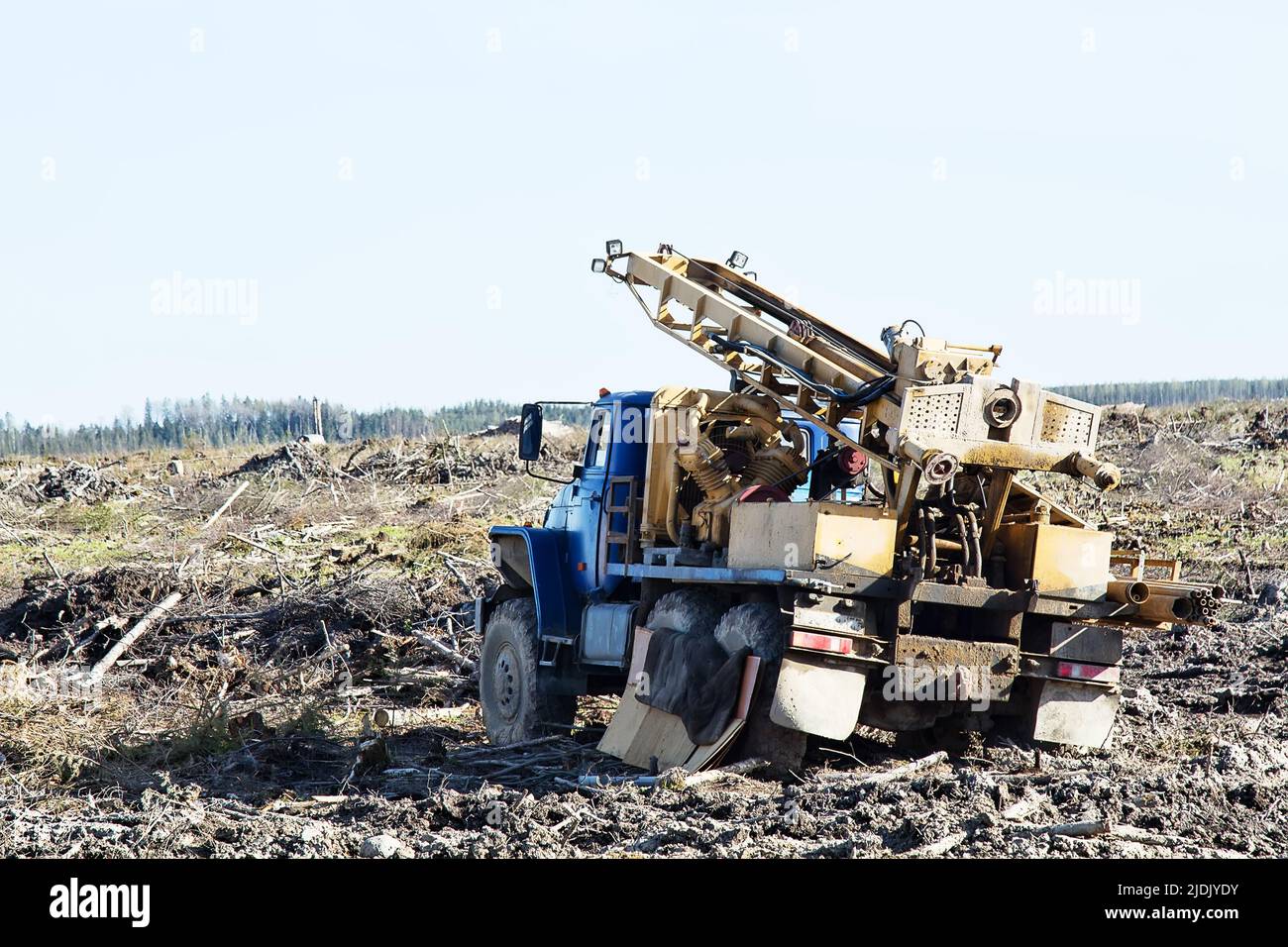 Vehiclebased drilling rig, wagon drill on the site of the sawn forest