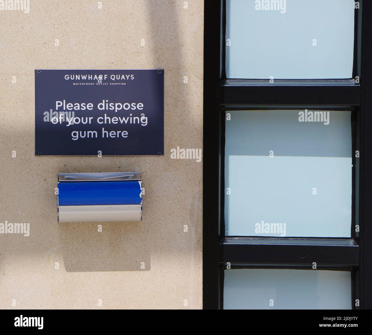 Sign and waste bin for chewing gum on a wall Gunwharf Quays Portsmouth