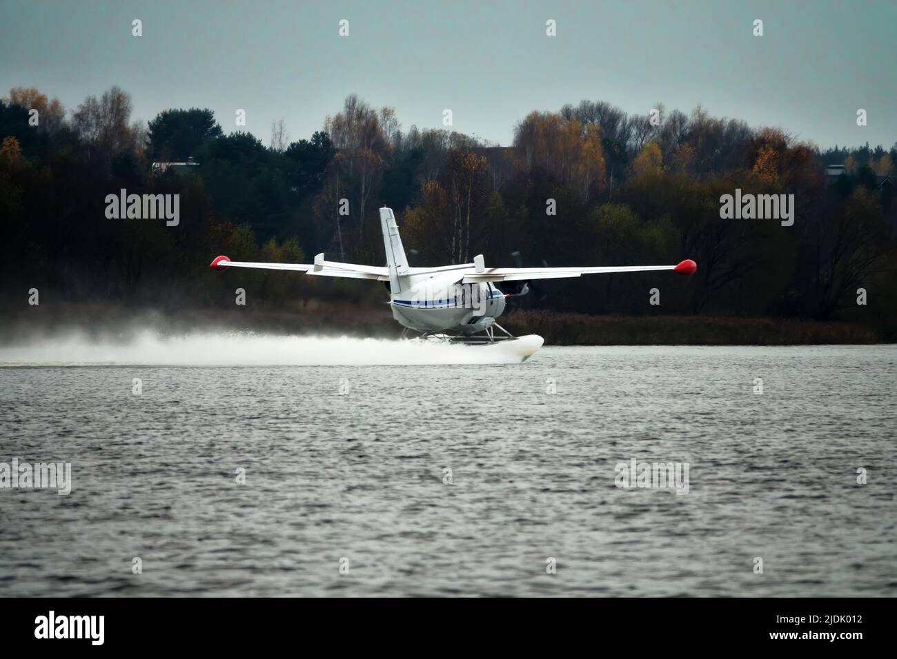 The Twinengine seaplane a seaplane rises from water, from the forest