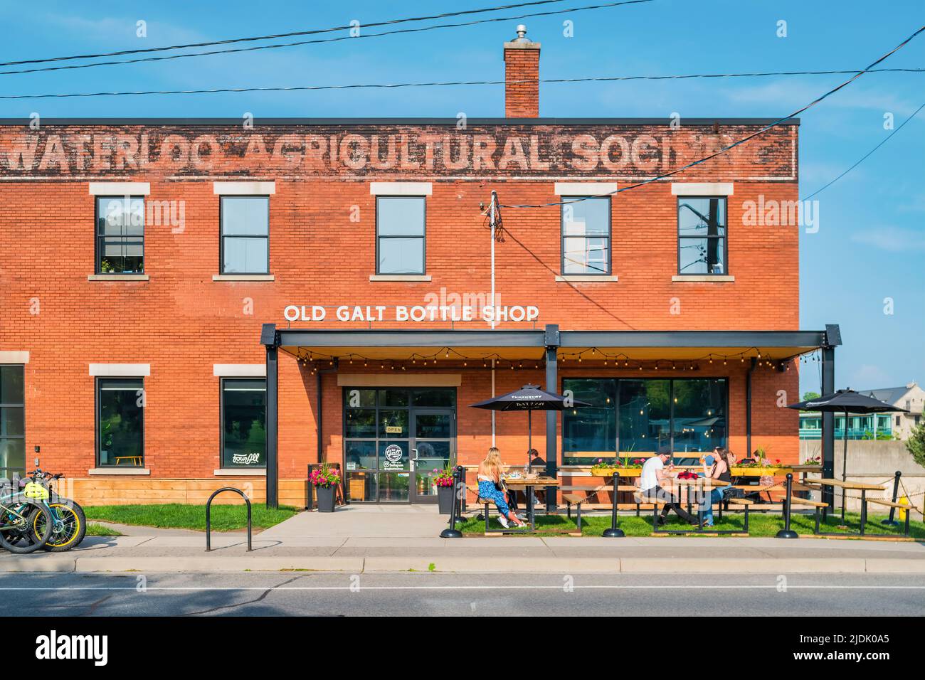 People sit on the patio of a bar-restaurant in downtown Cambridge, Ontario, Canada. Stock Photo
