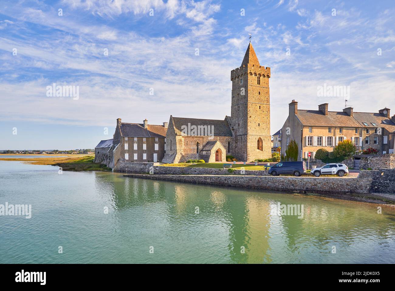 Image of Port Bail, Normandy, France with church at high tide.. Stock Photo